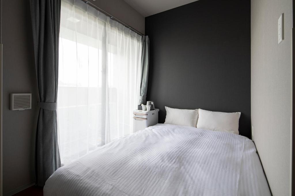 Postel nebo postele na pokoji v ubytování Grids Tokyo Ueno Hotel&Hostel
