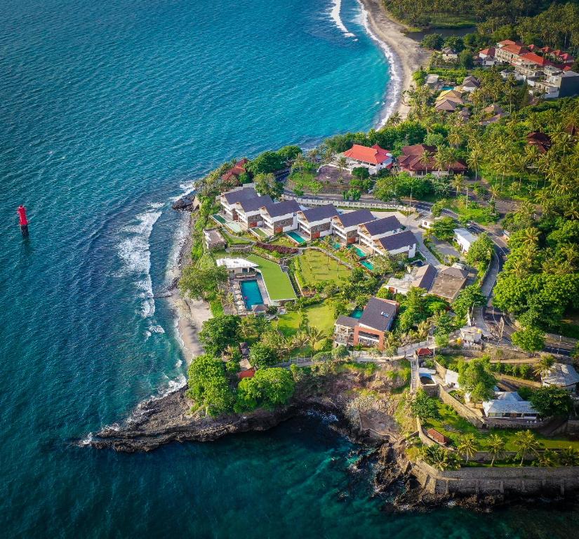 an aerial view of a house on a island in the ocean at Rajavilla Lombok Resort - Seaside Serenity in Senggigi