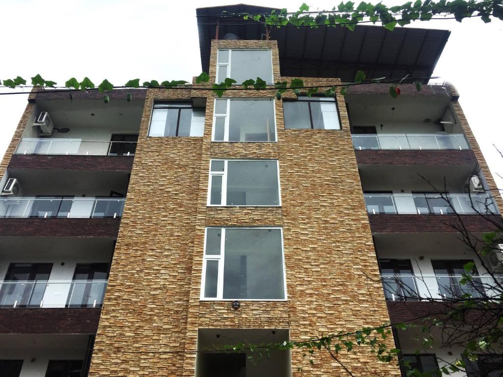 a tall brick building with white windows at Best Properties In Rishikesh in Rishīkesh