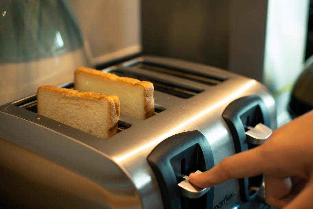 A four-slot toaster with two slices of bread being toasted.