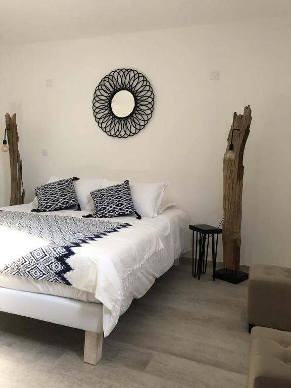 a bedroom with a bed and a mirror on the wall at Maxima Sunset in Sainte-Maxime