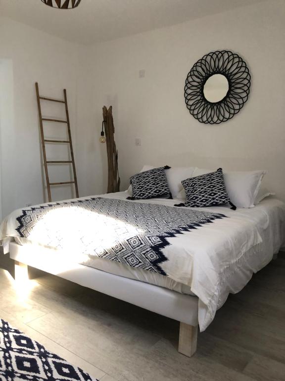 a bedroom with a bed with a mirror on the wall at Maxima Sunset in Sainte-Maxime