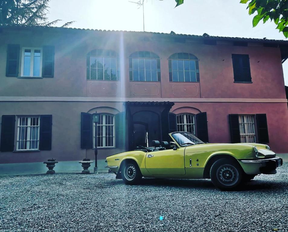 un'auto gialla parcheggiata di fronte a un edificio di VILLA ADRIANA a Bra