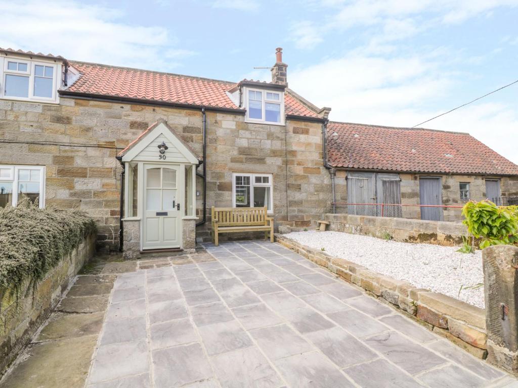 a stone driveway in front of a house at Cherry Cottage in Whitby