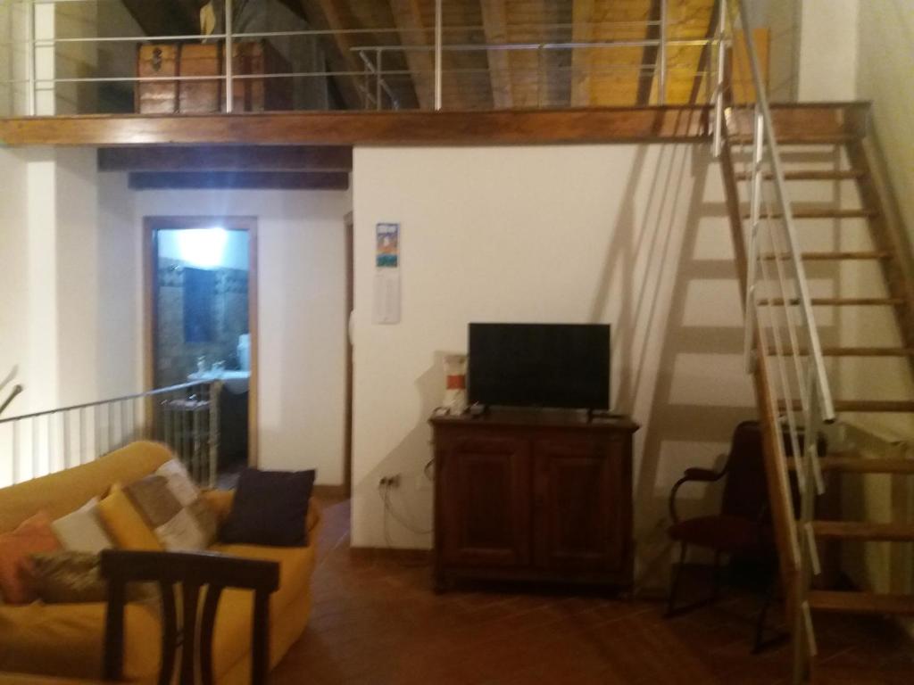 a living room with a loft bed and a tv at residence palladio in Rovigo