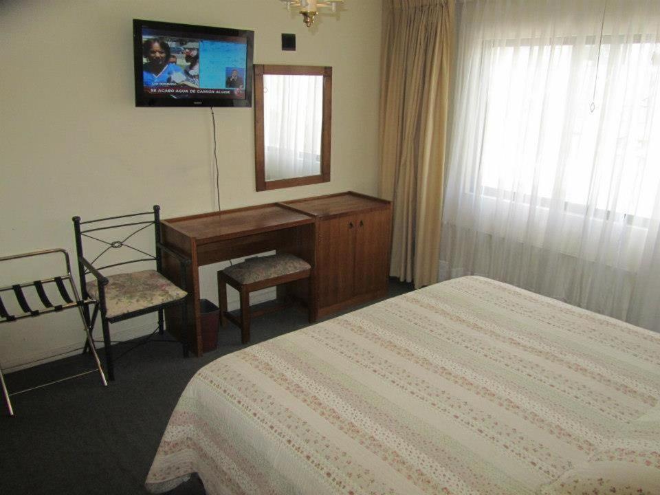 Postel nebo postele na pokoji v ubytování Hotel Quinchamali