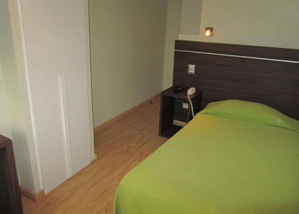 Postel nebo postele na pokoji v ubytování Hotel Quinchamali