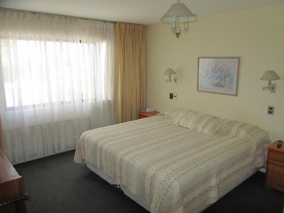 Postel nebo postele na pokoji v ubytování Hotel Quinchamali
