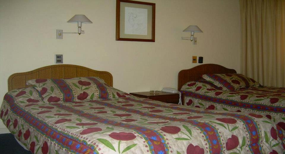 Postel nebo postele na pokoji v ubytování Hotel Quinchamali
