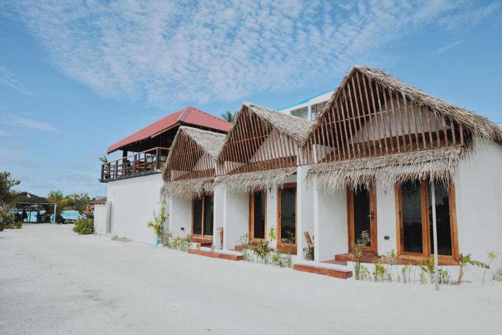 a house with a roof of straw at Club Kaafu Maldives in Dhiffushi