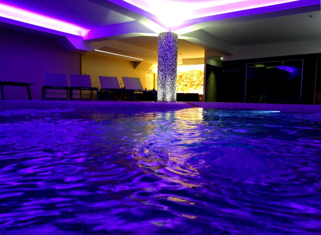 a swimming pool with purple lights in a room at Hotel delle Terme & SPA in Fiuggi