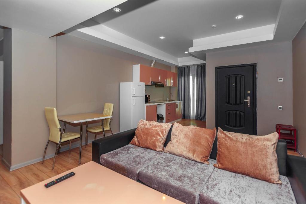 a living room with a couch and a table at Diplomat Suites in Baku