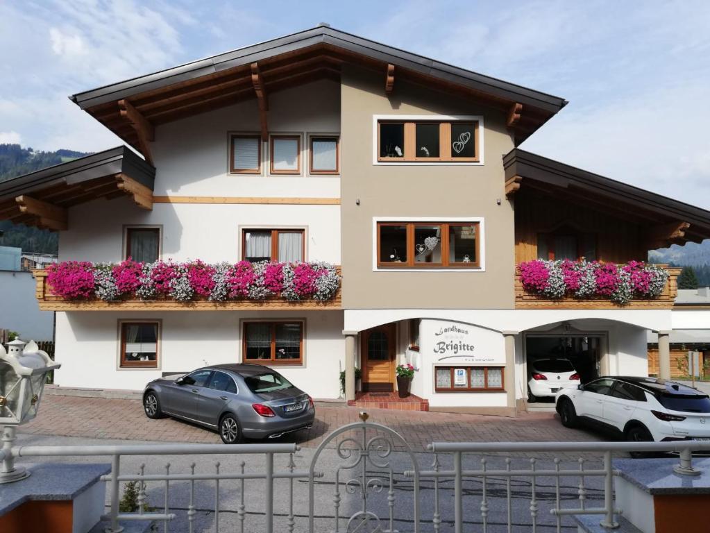 two cars parked in front of a building at Landhaus Brigitte in Flachau