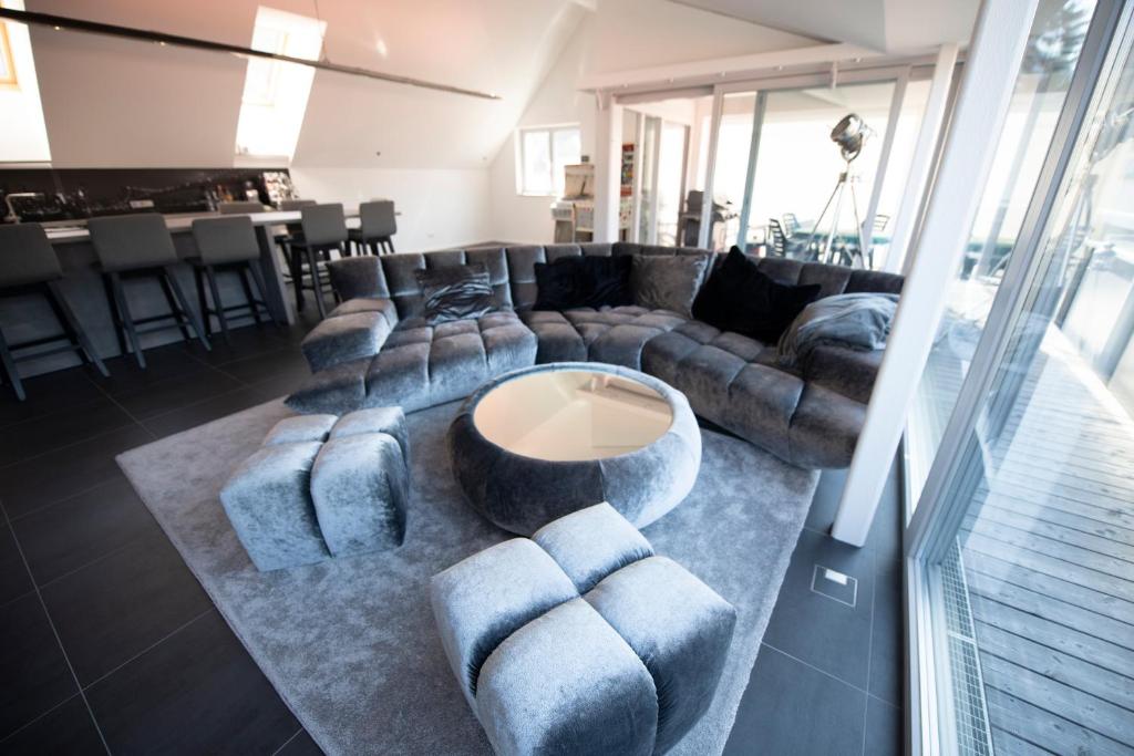 a living room with couches and a coffee table at Dachgeschoss Designer-Loft Arlberg - Montafon in Bludenz