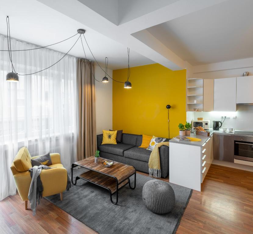 a living room with a couch and a table at City Leaf Apartments by Adrez in Prague