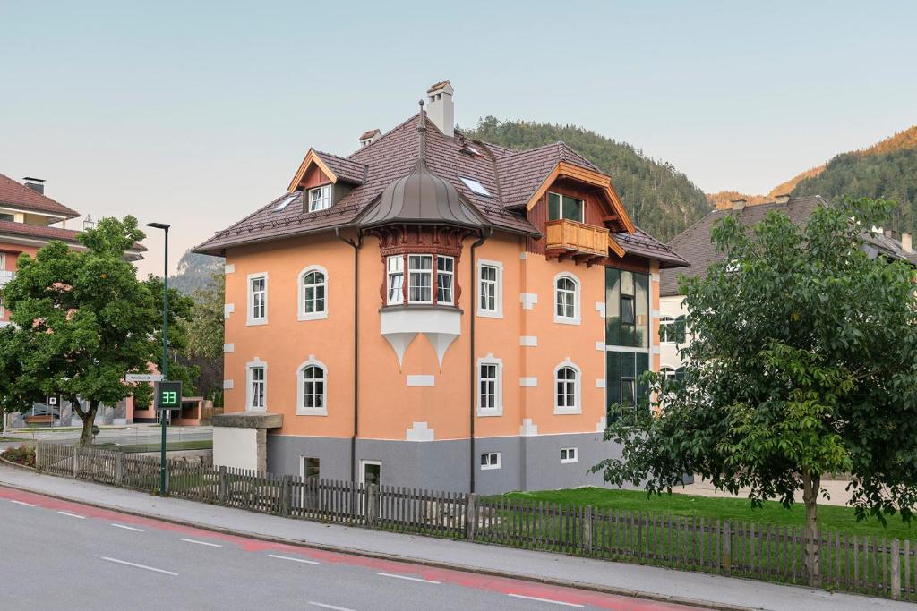 a large orange building on the side of a street at Villa Maria - Suiten & Appartement in Kufstein