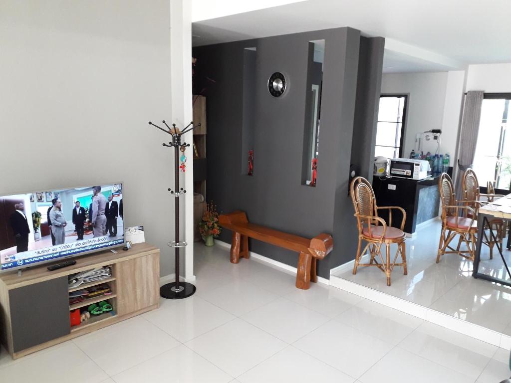 sala de estar con TV, mesa y sillas en New Loft Modern Home en Hang Dong