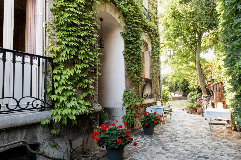 un edificio con flores a un lado. en Maison d'hôtes La Poterne, en Épernay