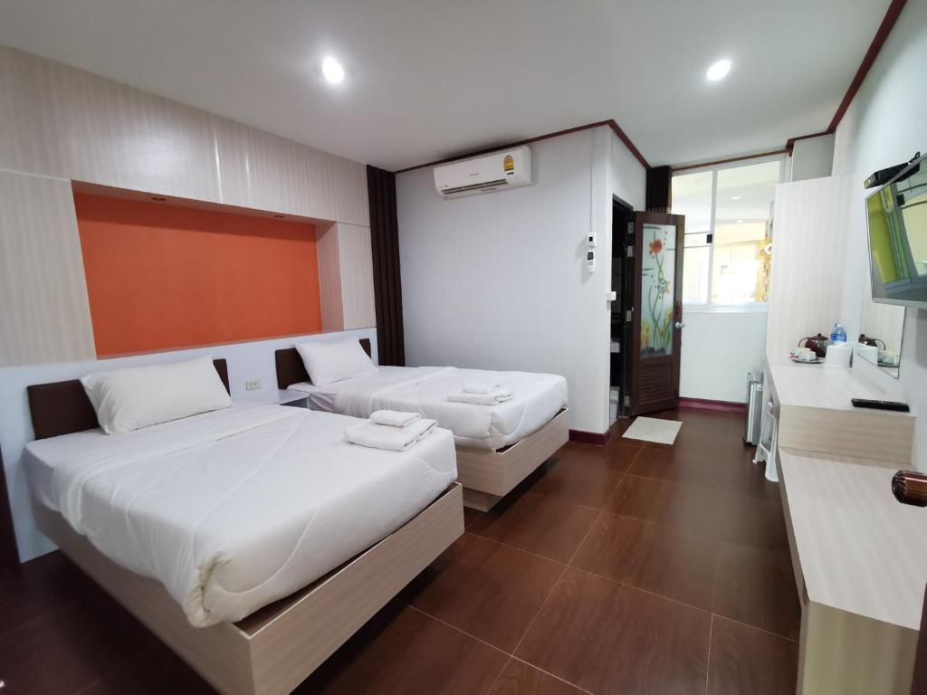 Postel nebo postele na pokoji v ubytování Honey Hotel Chiang Saen