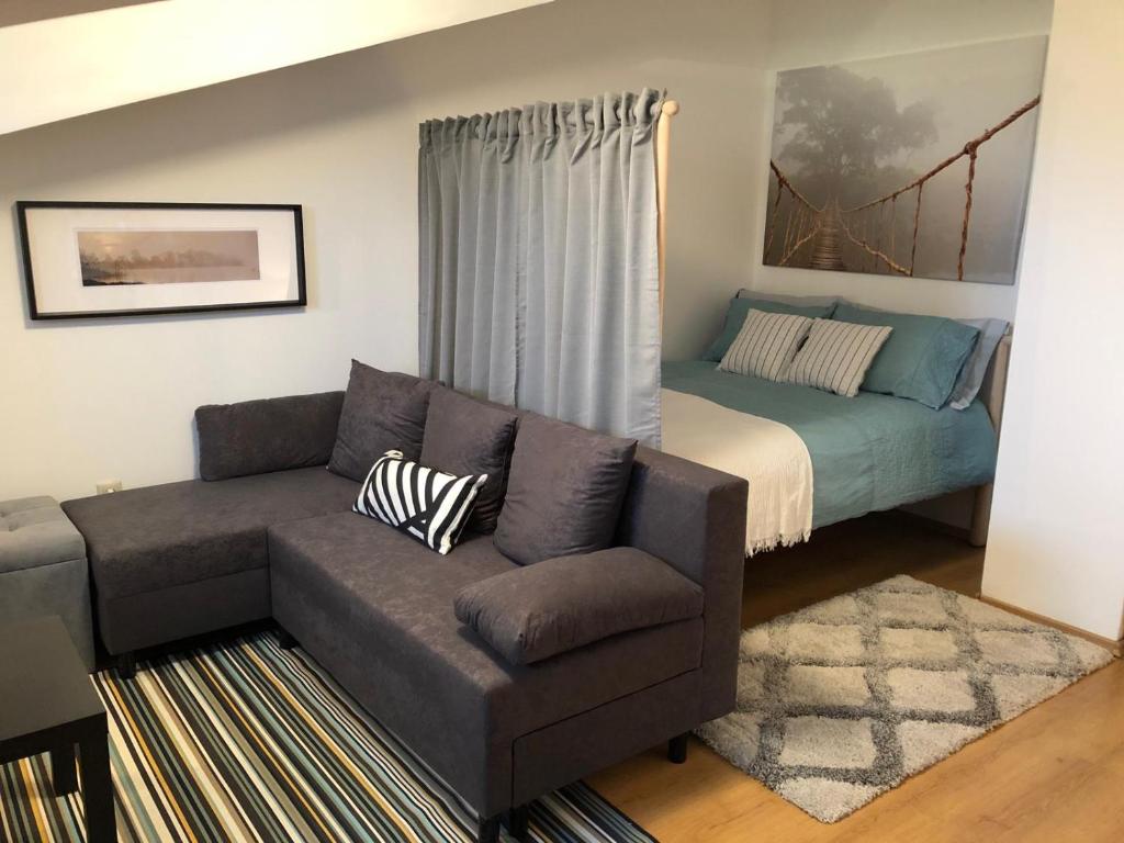a living room with a couch and a bed at Stylish Studio Apart Aspen Golf Resort in Razlog