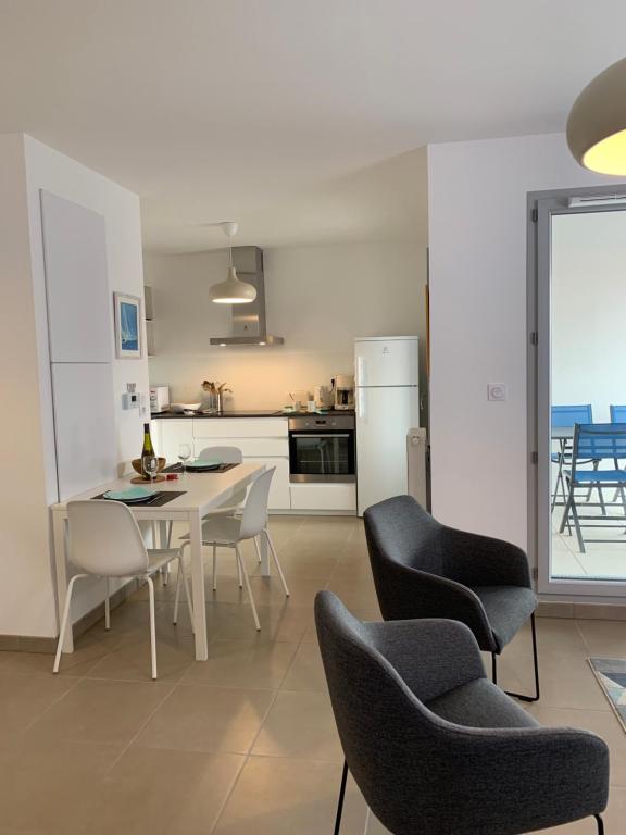 a kitchen and dining room with a table and chairs at LE CLOS SAINTE MARIE in Pornic