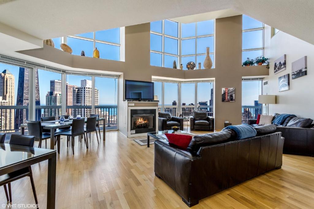 a living room with a view of the city at The Penthouse at Grand Plaza in Chicago