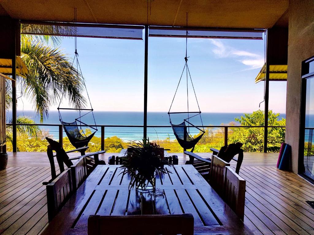 a room with a table with a view of the ocean at Santa Teresa Surf Vista Villas in Santa Teresa Beach