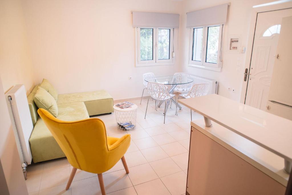 a kitchen with a table and a yellow chair in a room at Ioannina City Relax Apartment in Ioannina