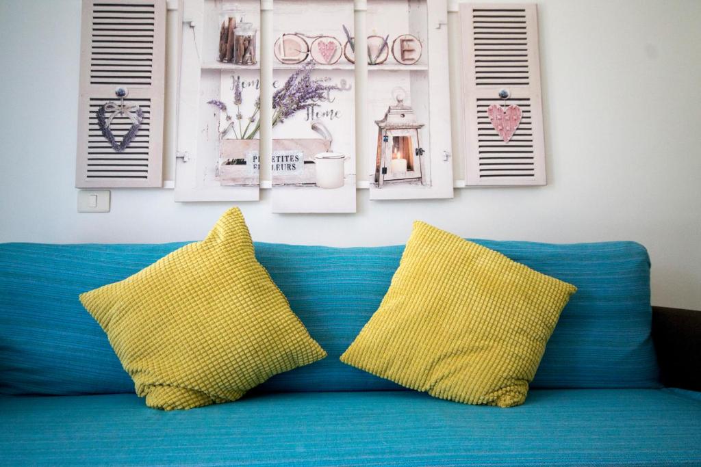 um sofá azul com duas almofadas amarelas em Cozy Apartment with Garden em Palm-mar