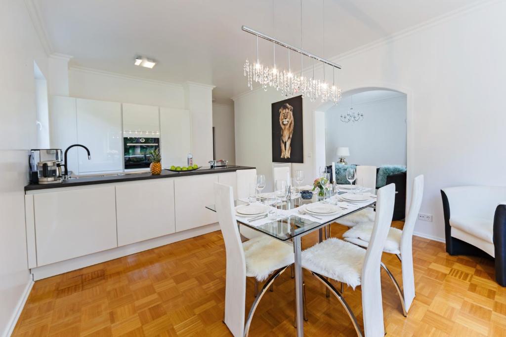 a kitchen and dining room with a table and chairs at Family Apartment City Center Baden-Baden in Baden-Baden