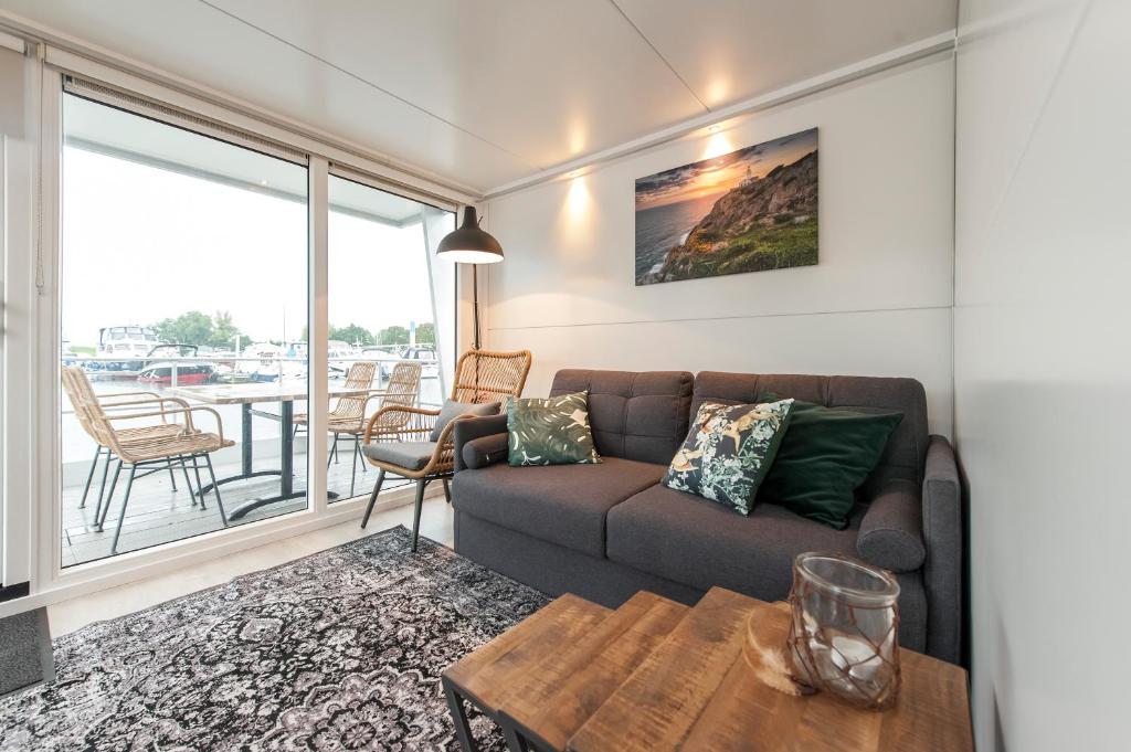 a living room with a couch and a table at Tiny floating house, Mallorca in Maastricht