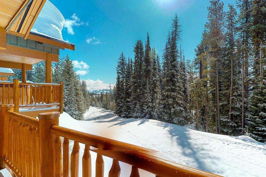 a porch of a house with snow covered trees at Silver Tip 6 in Big White