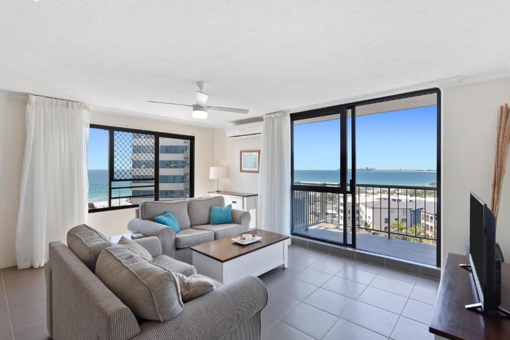 a living room filled with furniture and a window at Langley Park Apartments in Maroochydore