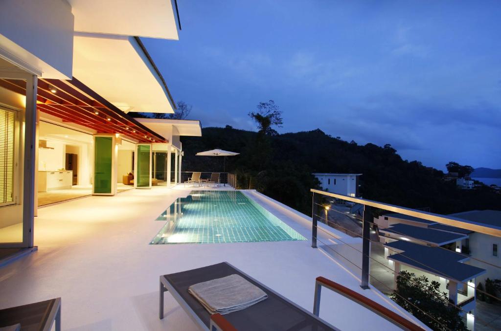 a swimming pool on the balcony of a house at Tian Blue Villa in Kamala Beach