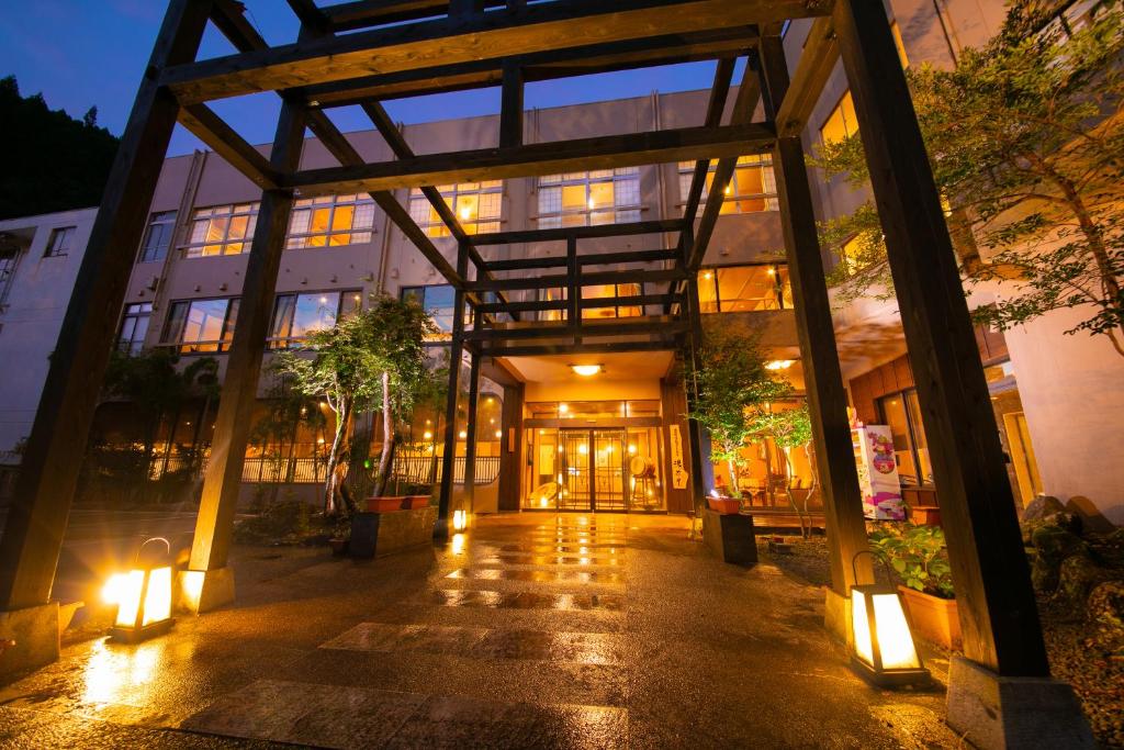 a building with lights in front of it at night at Hosenji Kanko Hotel Yumotoya in Kokonoe
