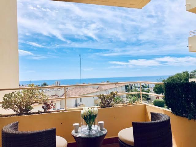 a balcony with a table and chairs and a view at Charming apartment with a stunning sea view in Málaga