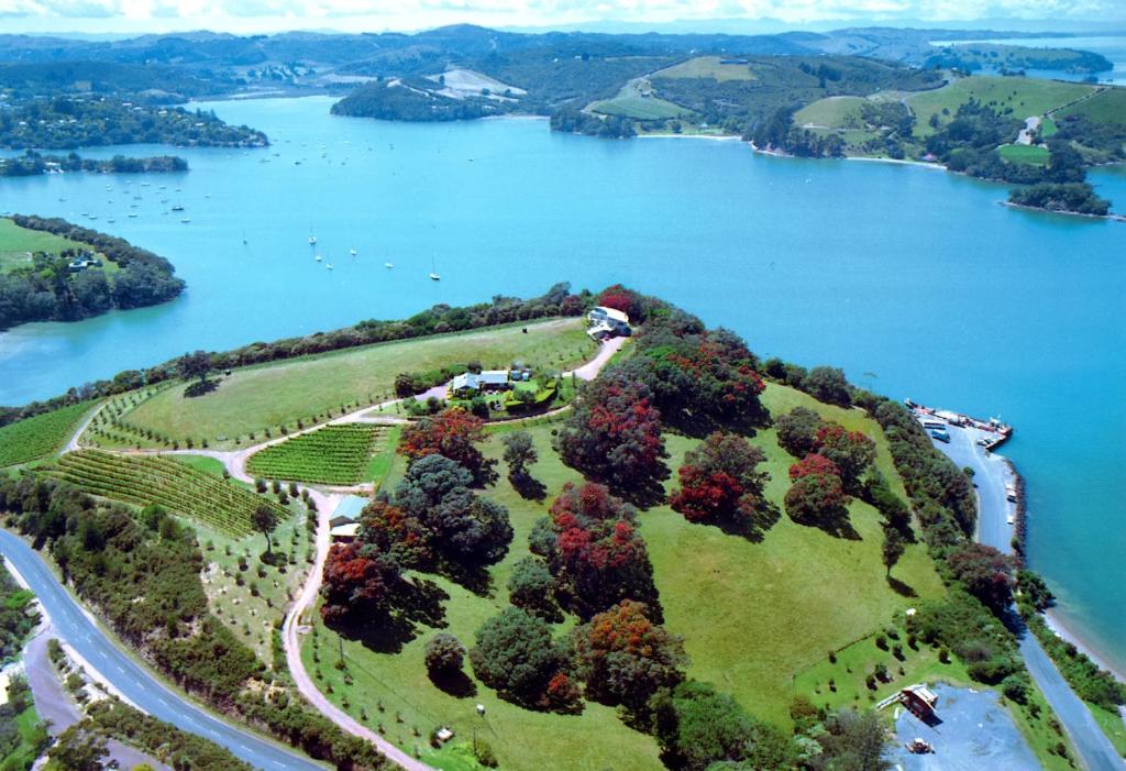 an island in the middle of a lake at Waiheke Island Vineyard Holiday Houses in Surfdale