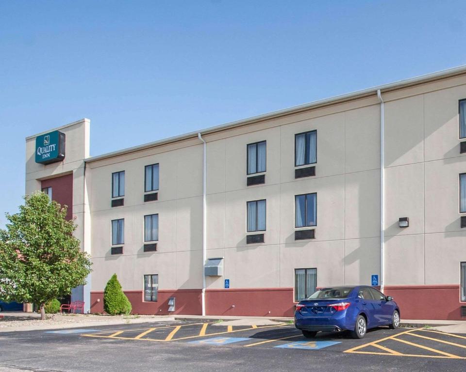 a blue car parked in front of a building at Quality Inn Joplin I-44 in Joplin