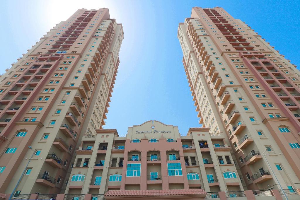 two tall buildings looking up at the sky at Super OYO 323 Home 417, Imperial Residence Tower B, Studio in Dubai