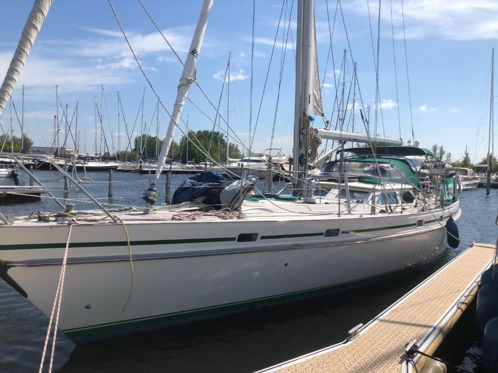a sailboat docked at a dock in the water at Adventures with friends & family stay only or learn to set sail with skipper Casey in Medemblik
