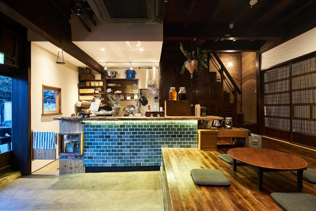 a kitchen with a blue tile counter and a table at ちゃぶだい Guesthouse,Cafe&Bar in Kawagoe