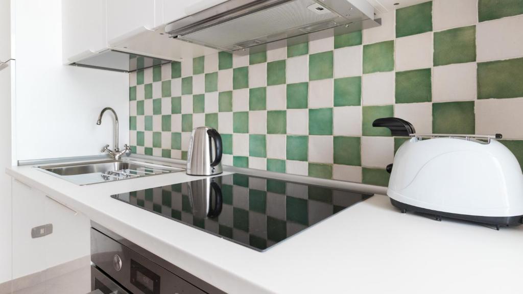 a kitchen with a sink and a toaster on a counter at Italianway - Ottoventi Apartments in Lampedusa