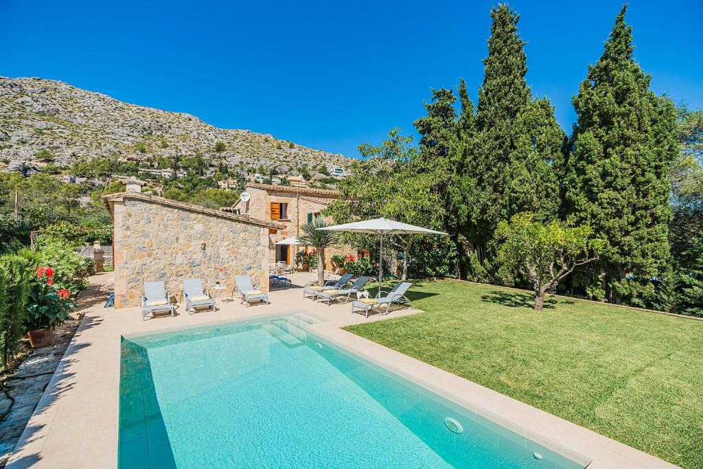 a house with a swimming pool in a yard at Villa Ull de La Font By SunVillas Mallorca in Pollença