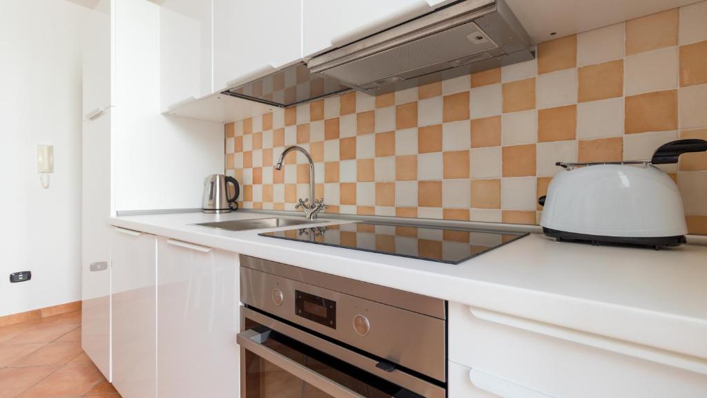 a kitchen with a sink and a toaster at Italianway - Ottoventi Apartments in Lampedusa