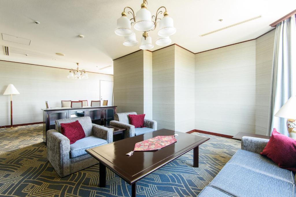 a living room with couches and a table at Kanazawa Tokyu Hotel in Kanazawa