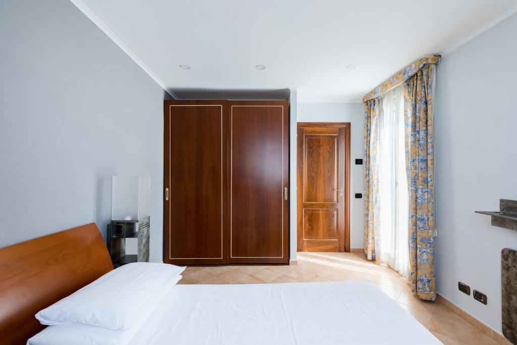 Łóżko lub łóżka w pokoju w obiekcie Crosti Apartments