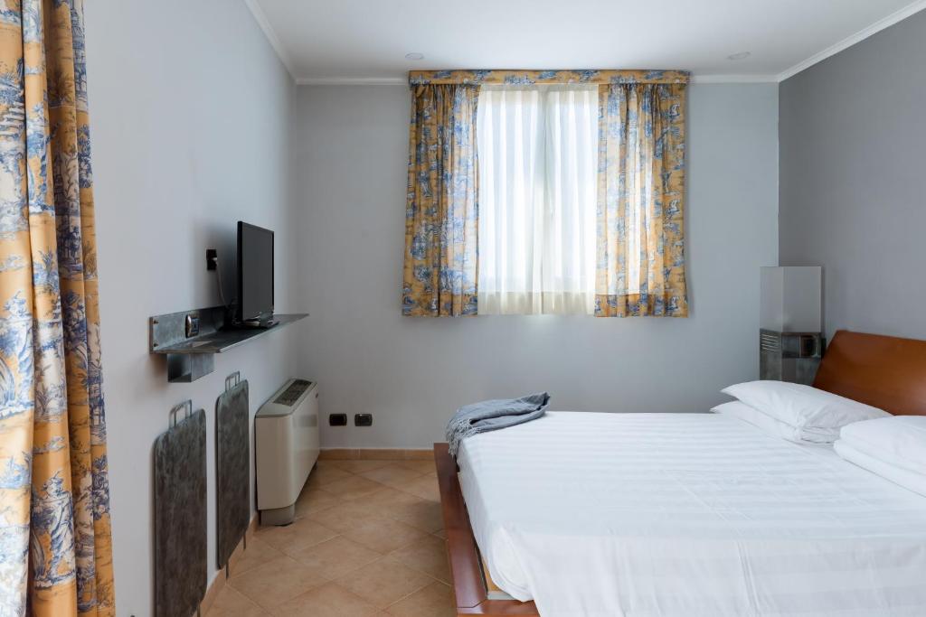 Łóżko lub łóżka w pokoju w obiekcie Crosti Apartments