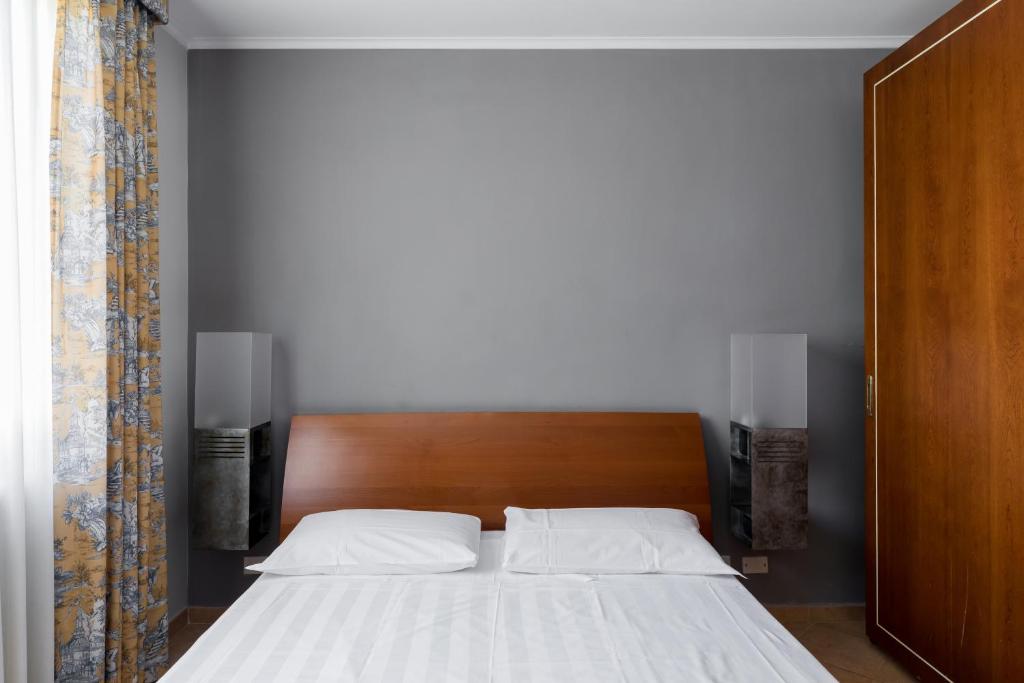 Łóżko lub łóżka w pokoju w obiekcie Crosti Apartments