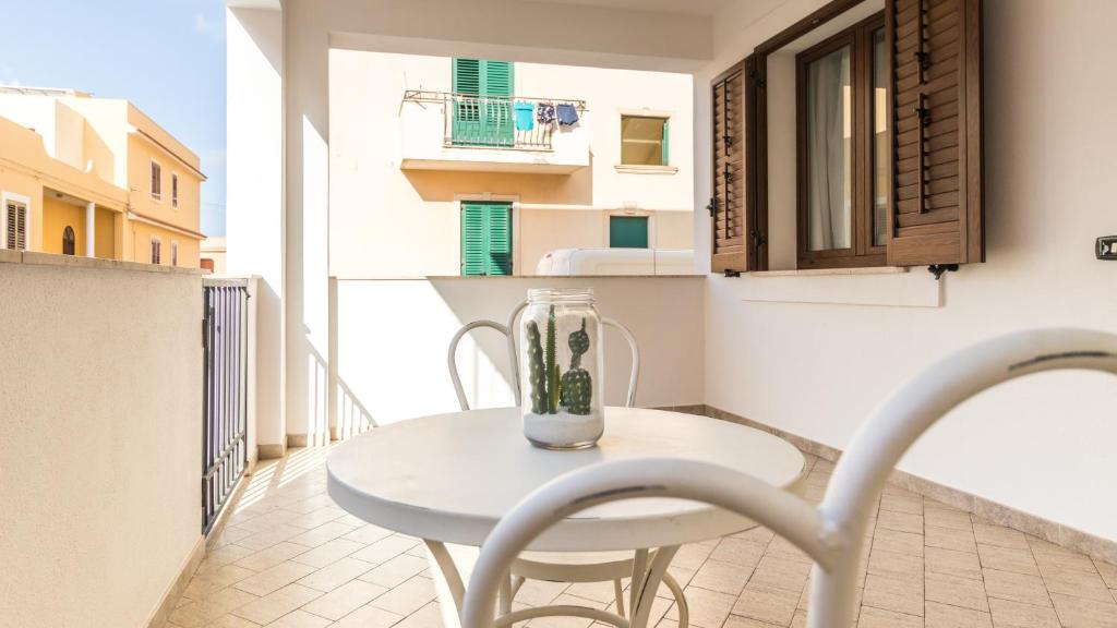 a white table with a blender on a balcony at Italianway - Ottoventi Apartments in Lampedusa