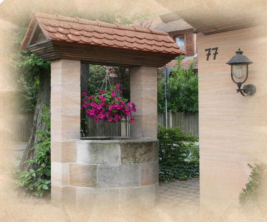 a window with a flower box with pink flowers in it at Gästehaus Wild in Oberasbach